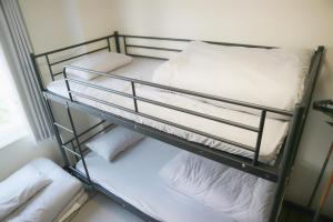 a bunk bed in a room with white pillows at Joynas Ise / Vacation STAY 31272 in Ise