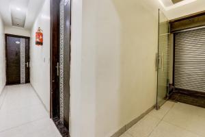 a hallway with a glass door and a walk in shower at Hotel O La Vista in Zirakpur