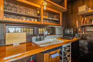 a kitchen with a sink and wooden cabinets at Minamiizu Yuhigaoka Camp Site - Camp - Vacation STAY 42067v in Ihama