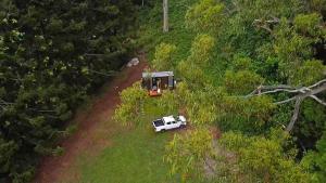 a white car parked in a field with a house at Montville Retreat by Tiny Away in Flaxton