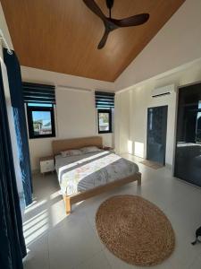 a bedroom with a bed and a ceiling fan at The Vista My Hoa in Ninh Hải +15 photos