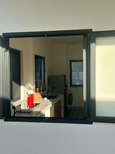 a mirror reflection of a kitchen in a room at The Vista My Hoa in Ninh Hải
