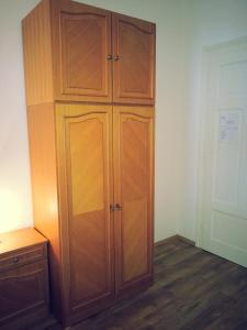 a large wooden cabinet in a room with wooden floors at Studio Apartman Kamelija in Opatija