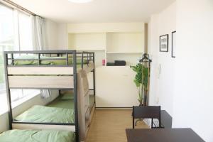 a room with two bunk beds and a table at Joynas Ise / Vacation STAY 32706 in Ise
