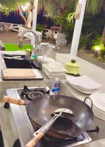 a pan sitting on top of a stove next to a sink at 南灣薇拉海景莊園 包棟Villa in Nanwan