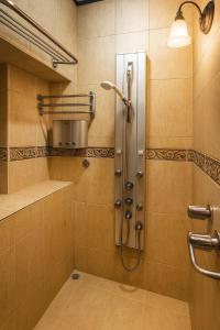 a shower stall in a bathroom with a shower at Hotel Mirador Mayday Mountain View in Alajuela City