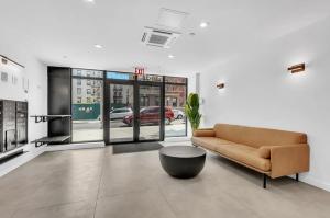 a living room with a couch and a coffee table at Elegant Studio Apartment in Steinway