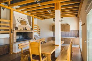 a dining room with a wooden table and a fireplace at Villa Diosa de la Aurora in Klis