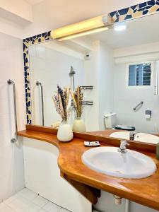 a bathroom with a sink and a mirror at Morphée Lodge in Saint-François