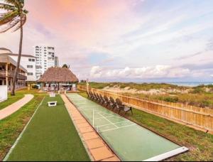 a group of benches sitting next to the beach at Beachfront Aparthotel in Deerfield Beach with Panoramic Views of the Ocean! in Deerfield Beach