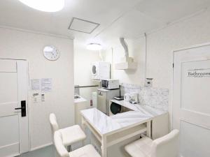 eine Küche mit Tisch und Stühlen in einem Zimmer in der Unterkunft Lavilla aveneu / Vacation STAY 73439 in Okinawa