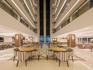 a restaurant with tables and chairs in a building at Prodigy Gramado by Wish in Gramado