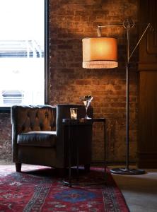 a living room with a couch and a lamp at Arthouse Hotel in New York