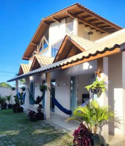 uma casa com uma rede na frente em Hospedagem MAR SANTO em Florianópolis
