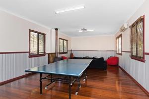 a ping pong table in the middle of a room at Jarrah Forest Lodge in Dwellingup
