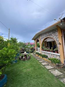 a garden with a table and a building at Subangan bayud3, Burgos central location in Burgos
