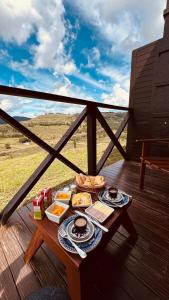 a tray of food on a table on a deck at Vinícola D'alture - CHALET CASAL in São Joaquim