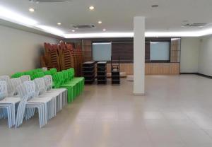 a room with green and white chairs and a podium at Hotel Grand Court Inn in Sungai Besar