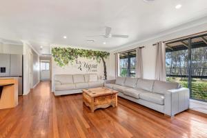 a living room with a couch and a table at Stay at Shiraz in Belford +13 photos