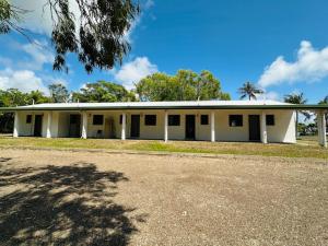 a large white building with a lot of windows at River of Gold Motel in Cooktown