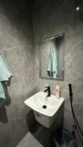 a bathroom with a white sink and a mirror at Vant in Riyadh