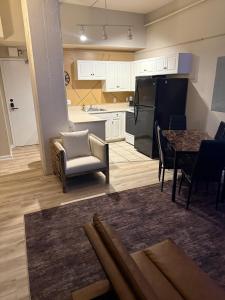 a kitchen and dining room with a table and a refrigerator at Downtown Loft Free Street Parking Gym w Sauna in Cleveland