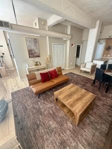 a living room with a couch and a coffee table at Downtown Loft Free Street Parking Gym w Sauna in Cleveland