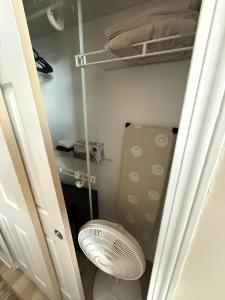 a small room with a closet with a fan at Downtown Loft Free Street Parking Gym w Sauna in Cleveland +24 photos