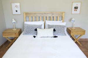 a bedroom with a white bed with pillows at Sleep-A-Lot in Piet Retief