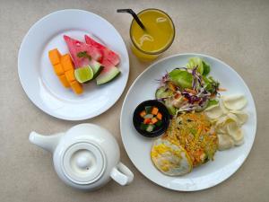a table with two plates of food and a teapot at Private Pool Villas Seven Twenty Kuta in Badung