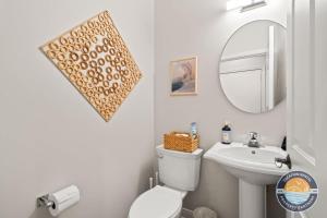 a bathroom with a sink and a toilet and a mirror at Fontana Retreat Walk to Lake Pool Golf King Suites in Lake Geneva +28 photos