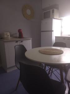a kitchen with a table and chairs and a refrigerator at Costa Pinar in El Pinar