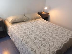 a bedroom with a bed with a white comforter at Costa Pinar in El Pinar +2 photos