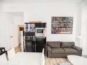 a living room with a couch and a microwave at Malaga BnB in Málaga
