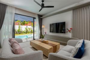 a living room with a couch and a tv at Kiang Tawan Villa 2 