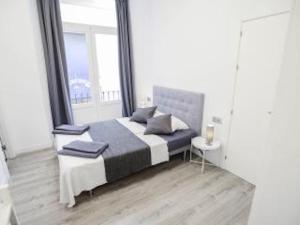 a bedroom with a bed and a large window at Malaga BnB in Málaga +4 photos