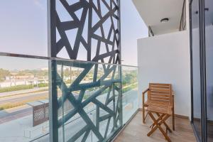 a room with a chair and a window at Masdar Modern Studio in Abu Dhabi