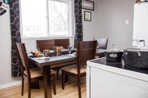 a dining room with a table and chairs and a window at 197 Le Maire Street in Winnipeg