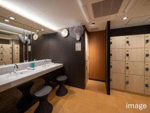a bathroom with two sinks and a large mirror at APA Hotel Oita Ekimae in Oita +81 photos