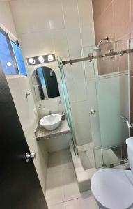 a bathroom with a glass shower and a sink at DEPARTAMENTOS, a una calle de la PLAYA Y MALECÓN in Salinas