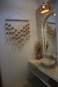 a bathroom with a sink and a mirror at Momy Breeze Uluwatu in Bingin Beach