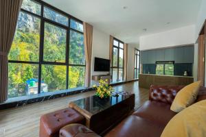 a living room with a couch and a table at Viet Hoa Hotel & Residence Cat Ba - Rooftop Pool in Cat Ba