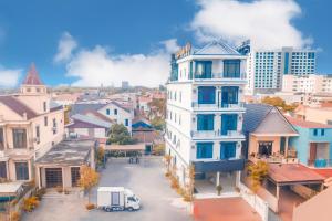 a white building in the middle of a city at Tan Hoang Minh Hotel in Dong Hoi +59 photos