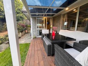 Hillpark Hideaway في أوكلاند: فناء مع طاولة وكراسي على السطح
