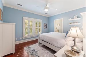 a bedroom with blue walls and a bed with a lamp at BW3038: 3038 Baywood Drive in Seabrook Island +46 photos