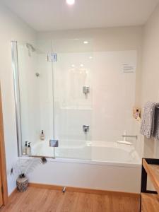 a bathroom with a bath tub and a shower at Channel View Havelock in Havelock