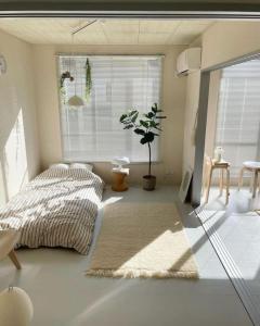 a bedroom with a bed and a window and a rug at Intan Vallez Apart in Jambi