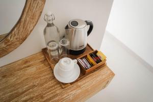 a tray with a coffee maker and a coffee pot on a table at Cavahills Cottage in Denpasar