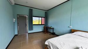 Ένα ή περισσότερα κρεβάτια σε δωμάτιο στο sokxay guesthouse