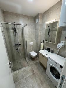 a bathroom with a shower and a toilet and a sink at Damar Vista in Divčibare +12 photos